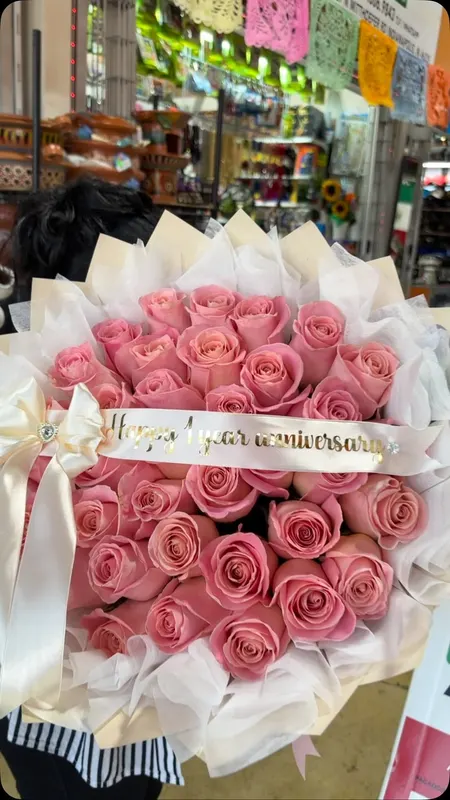 Pink rose bouquet with a Happy anniversary sash