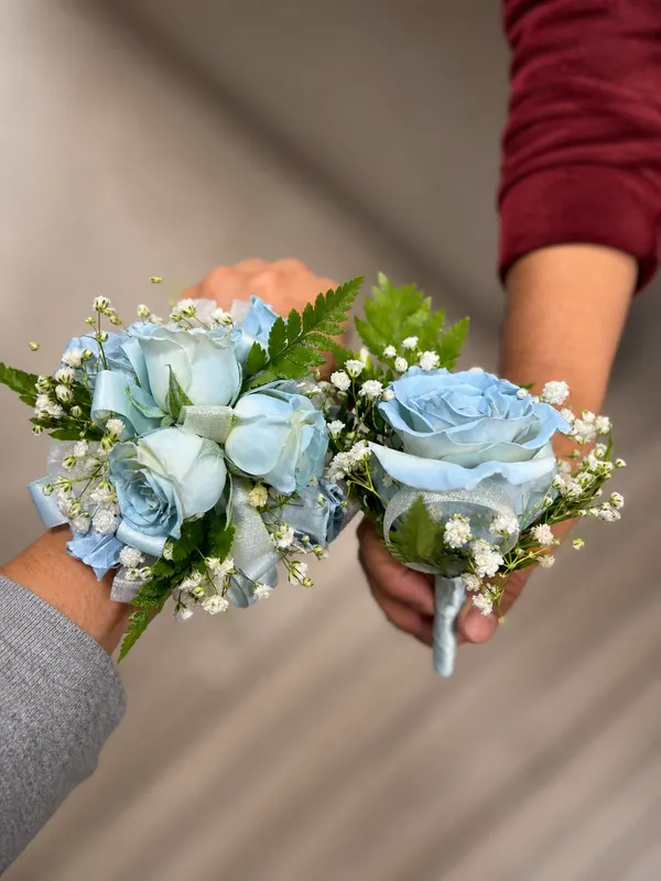 Sky-blue rose wrist corsage and matching boutonniere