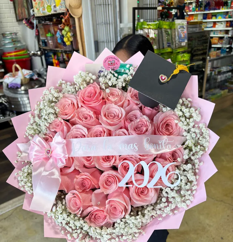 Pink rose graduation bouquet with a grad cap and a 2026 sash