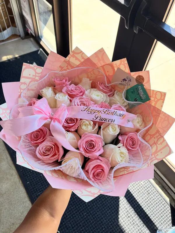 Pink and white rose bouquet with a printed sash